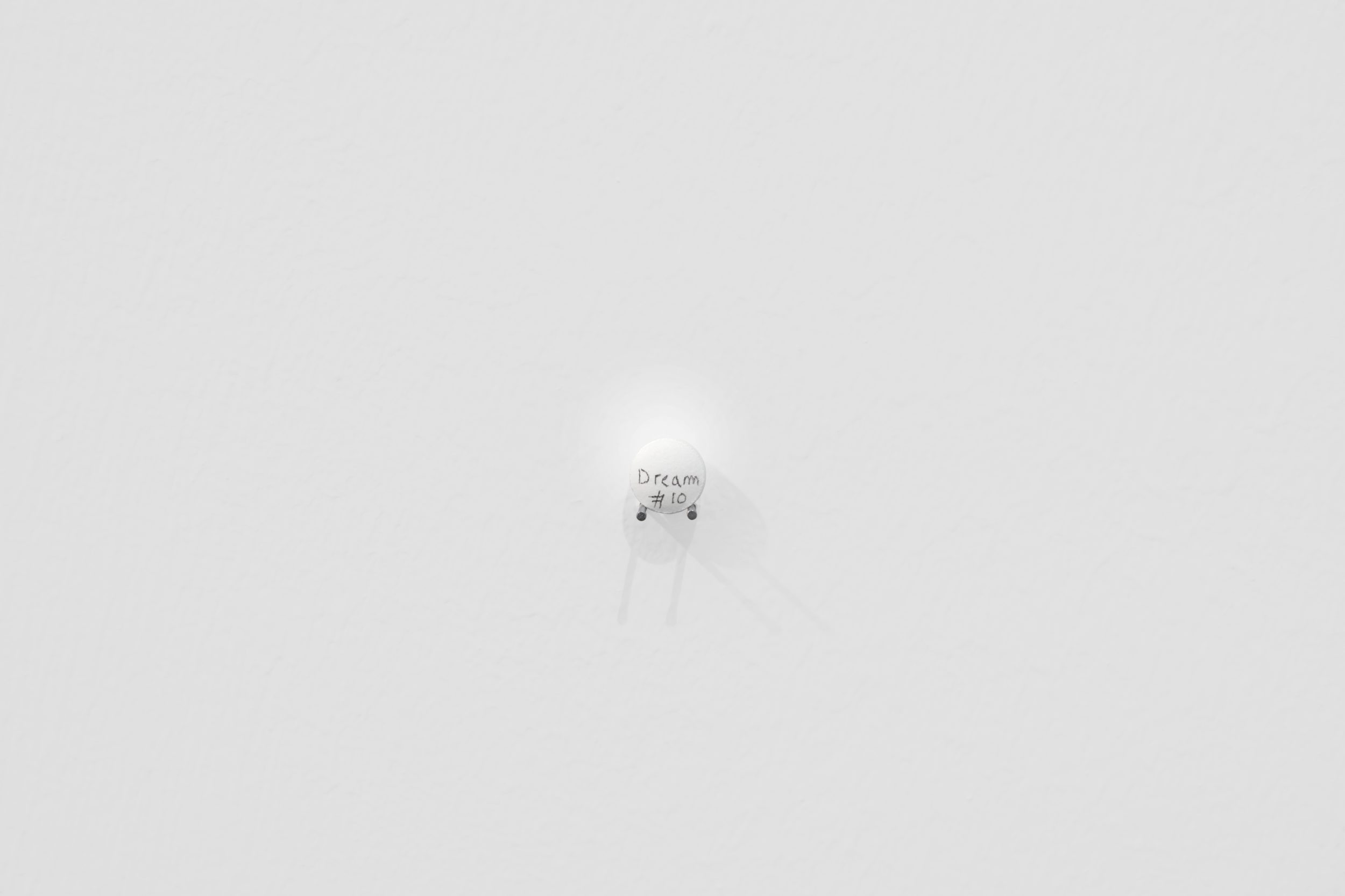 Charbel-joseph H. Boutros, Dream Pill #1, 2024. Pill, dream, exhibition, metallic nails. 1 x 1 x 0,5 cm. Unique in a series
