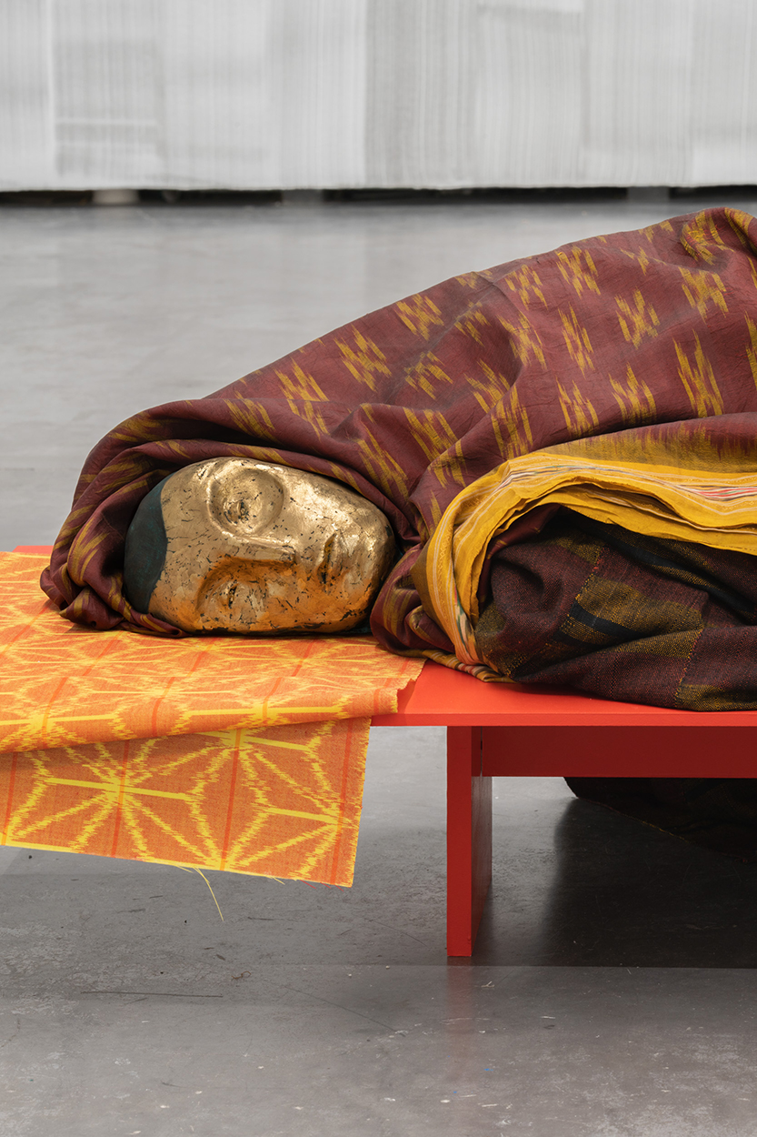 


André Romão, Inverno (detail), 2025. Polichromed and guilt clay, painted wood, bronze, Kente cloth (cotton, Ewe, c1950), Patola (silk, India, c.1970), Kasuri (hemp, Japan, showa era). 50 x 175 x 55 cm. Unique



