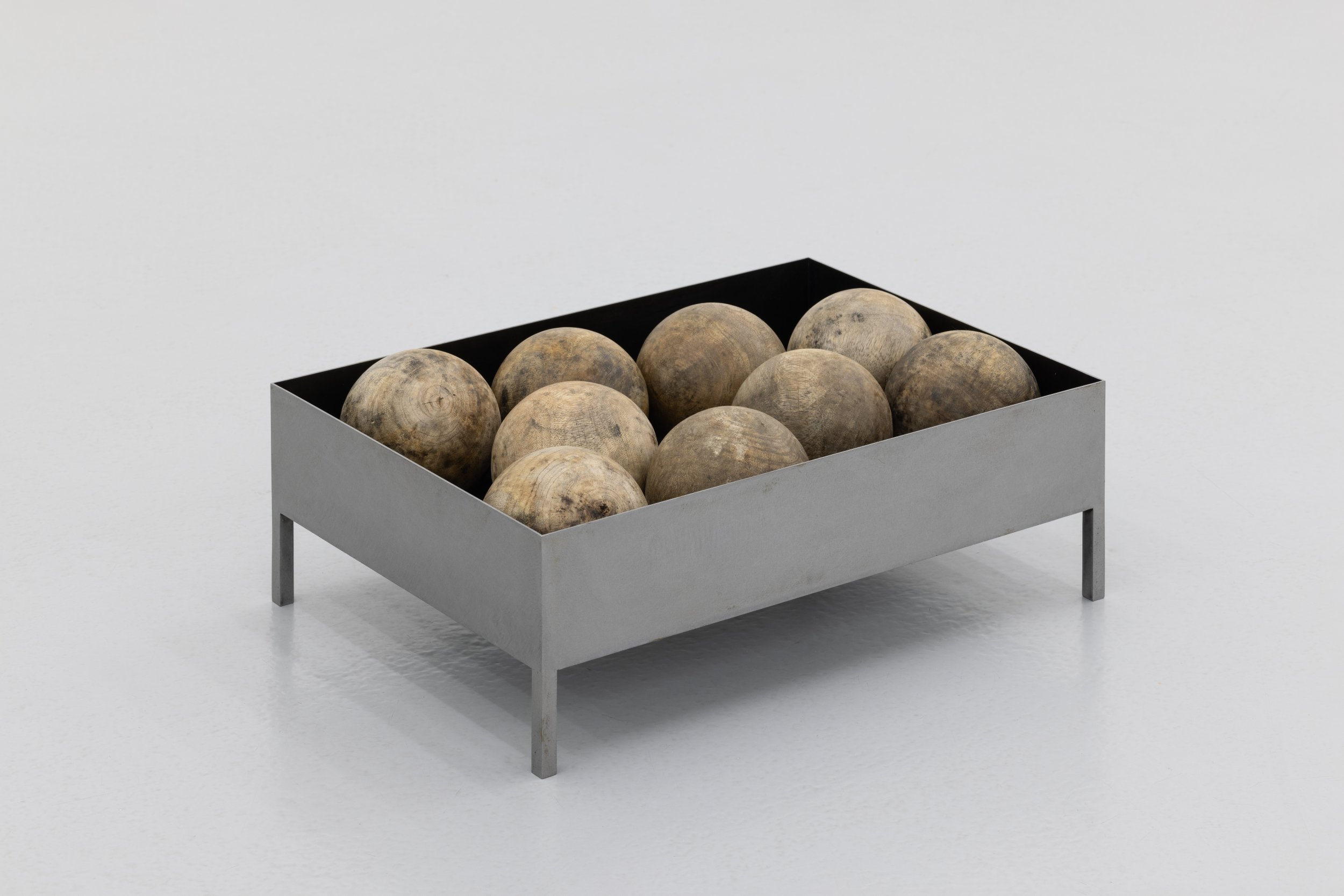 Daniel Gustav Cramer, CIV, 2023. Wooden spheres in box, metal box. Box 41 x 29 x 11. Unique. 9 antique wooden spheres gathered inside a box
