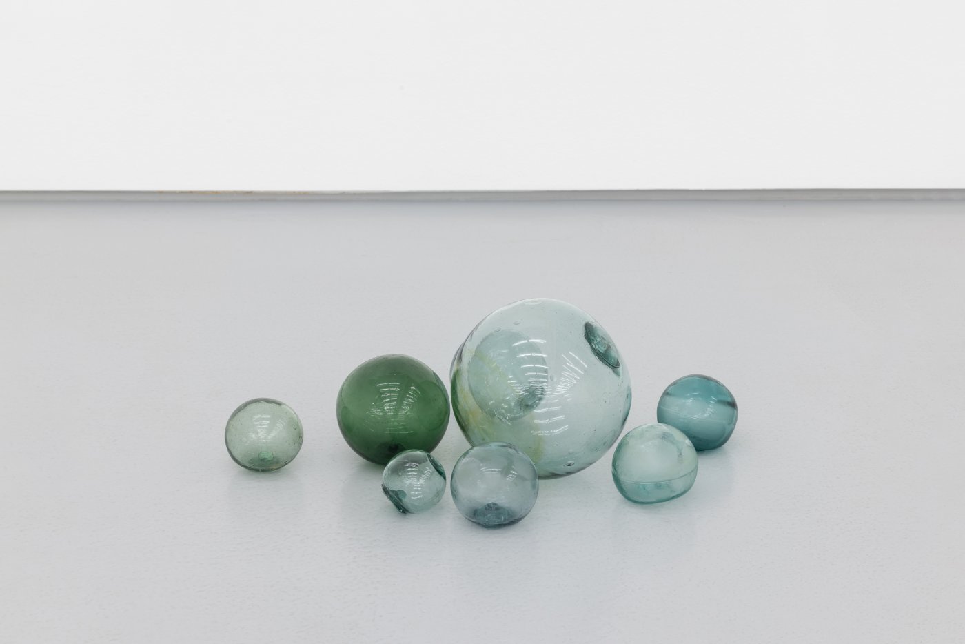 Daniel Gustav Cramer, XC, 2022. 7 japanese ukidamas. Glass spheres found over a period of several years at beaches around Point Hope, Alaska, acquired in 2014
