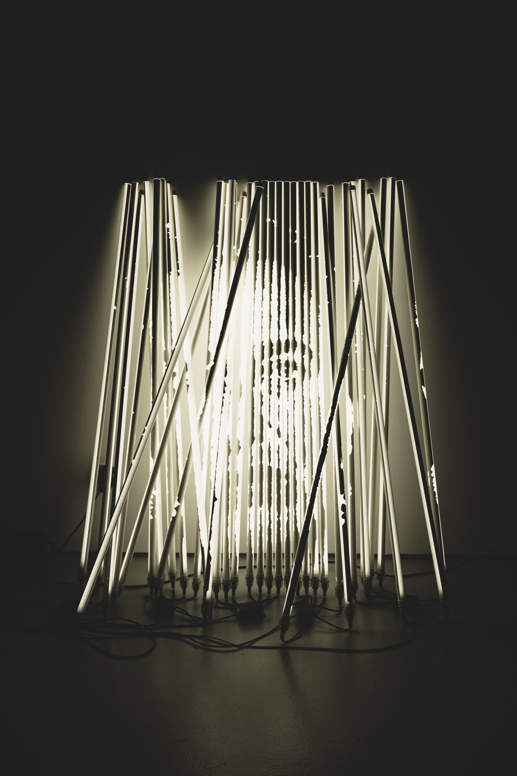 Alexandre Farto aka Vhils, Diafragma Series #06, 2024. Tubular lights with stencil mask and microcontrollers. 151 x 75 x 48 cm. © Alexander Silva
