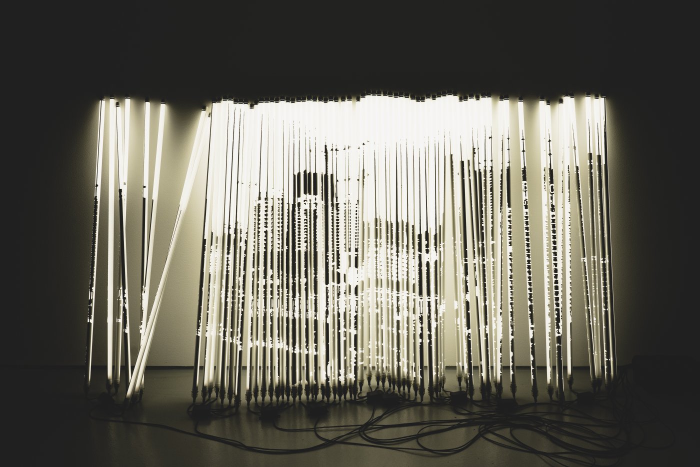 Alexandre Farto aka Vhils, Diafragma Series #07, 2024. Tubular lights with stencil mask and microcontrollers. 152 x 269 x 52 cm. © Alexander Silva
