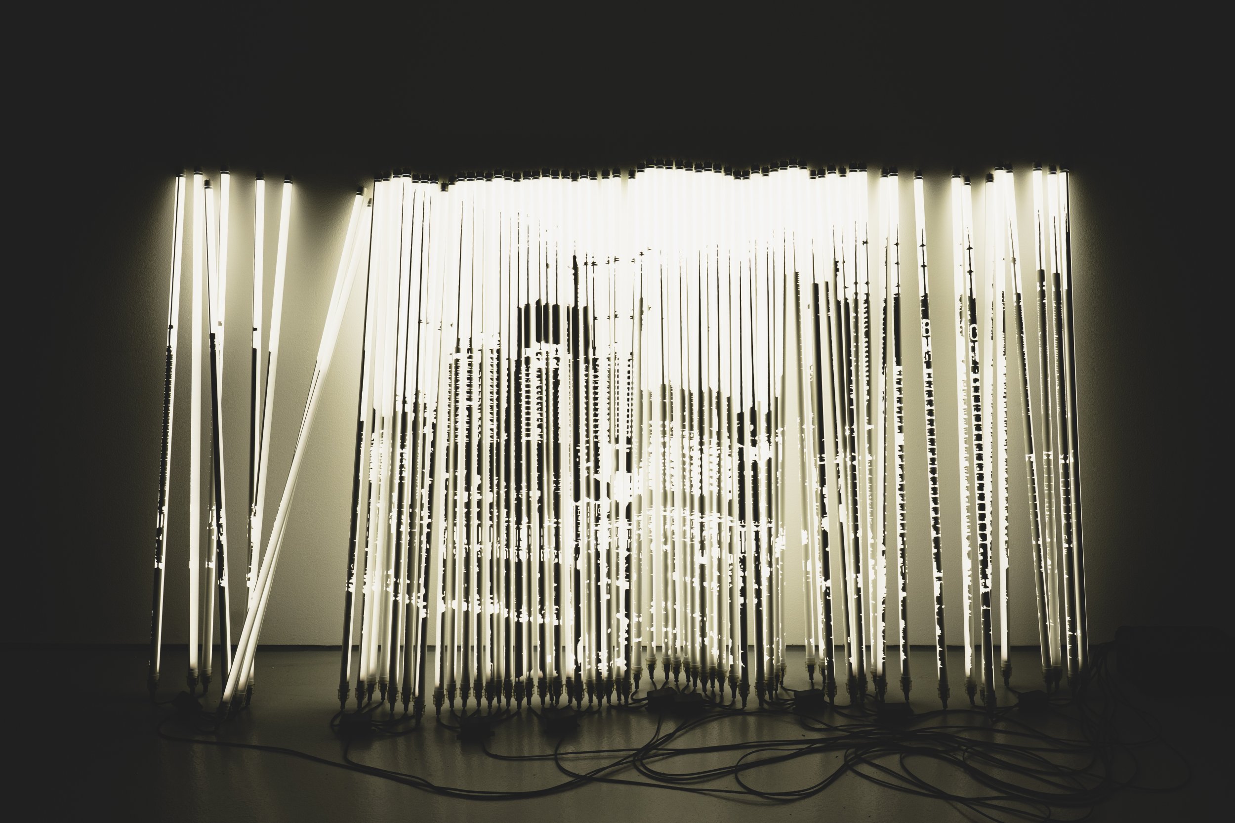 Alexandre Farto aka Vhils, Diafragma Series #07, 2024. Tubular lights with stencil mask and microcontrollers. 152 x 269 x 52 cm. © Alexander Silva
