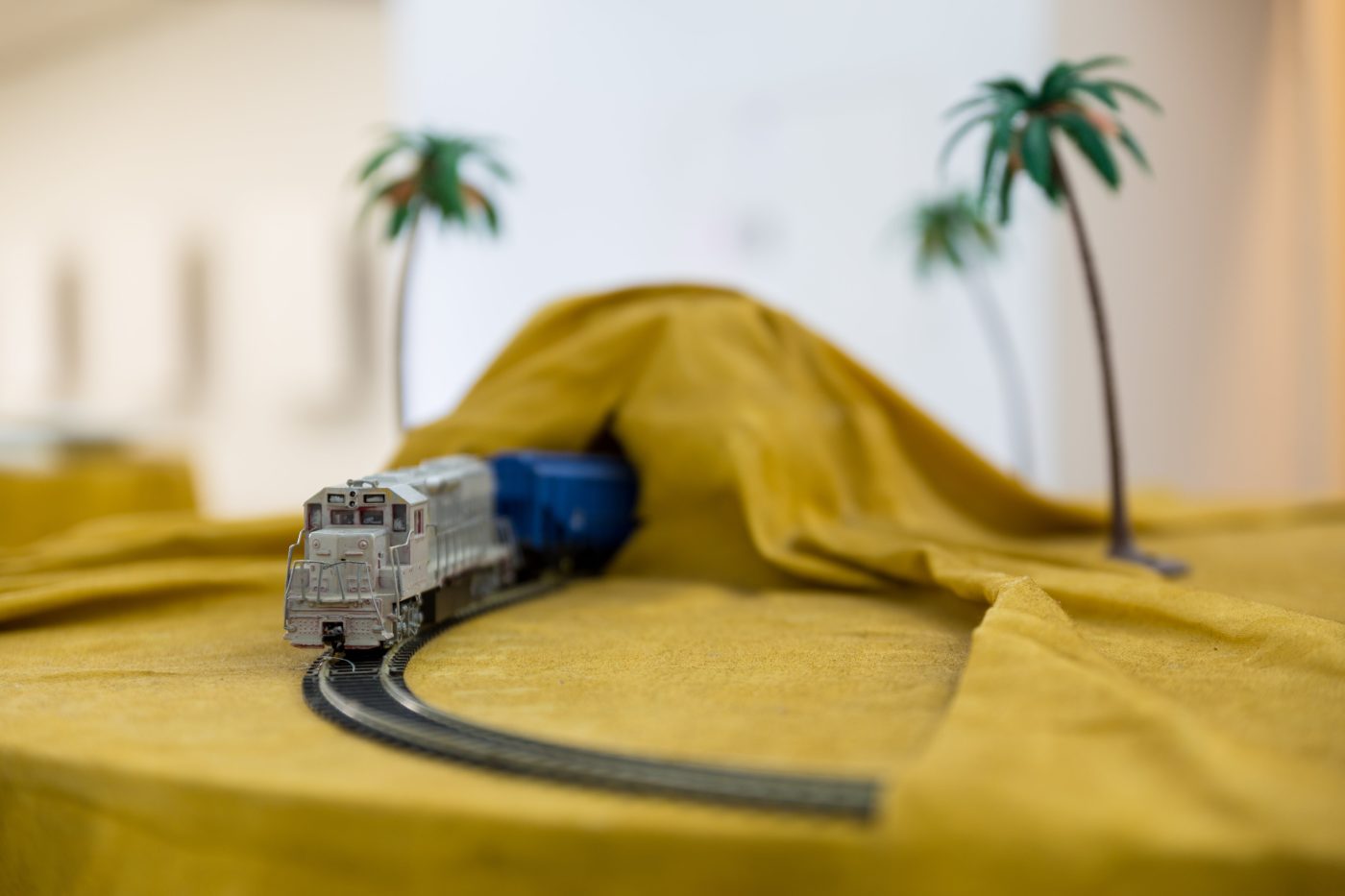 Ana Vieira, Mesa-Paisagem (detail), 1973. 94 x Ø 110 cm.  Wooden table, fabric, spray paint on fabric, metal, ceramics, and objects (1 plate, cutlery, napkin ring, napkin, sand, boat).Unique
