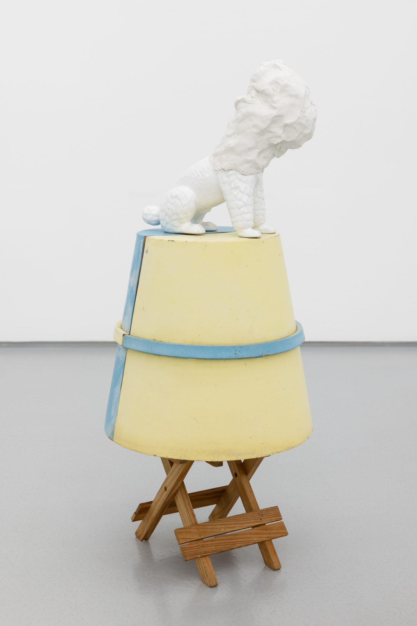 Susanne S. D. Themlitz, Coucou, 2025. Ceramic, modeling clay, wood, painted iron. 82 x 35 x 35 cm