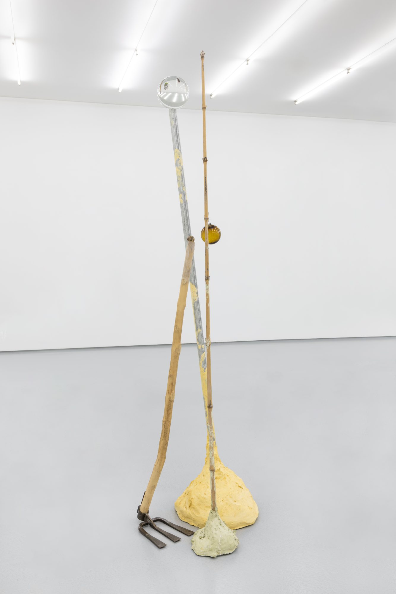 Susanne S. D. Themlitz, Trio (The World Upside Down), 2025. Pigmented plaster, aluminum, iron, wood, bamboo, crystal ball, glass ball, wire, snail shell. 190 x 40 x 50 cm