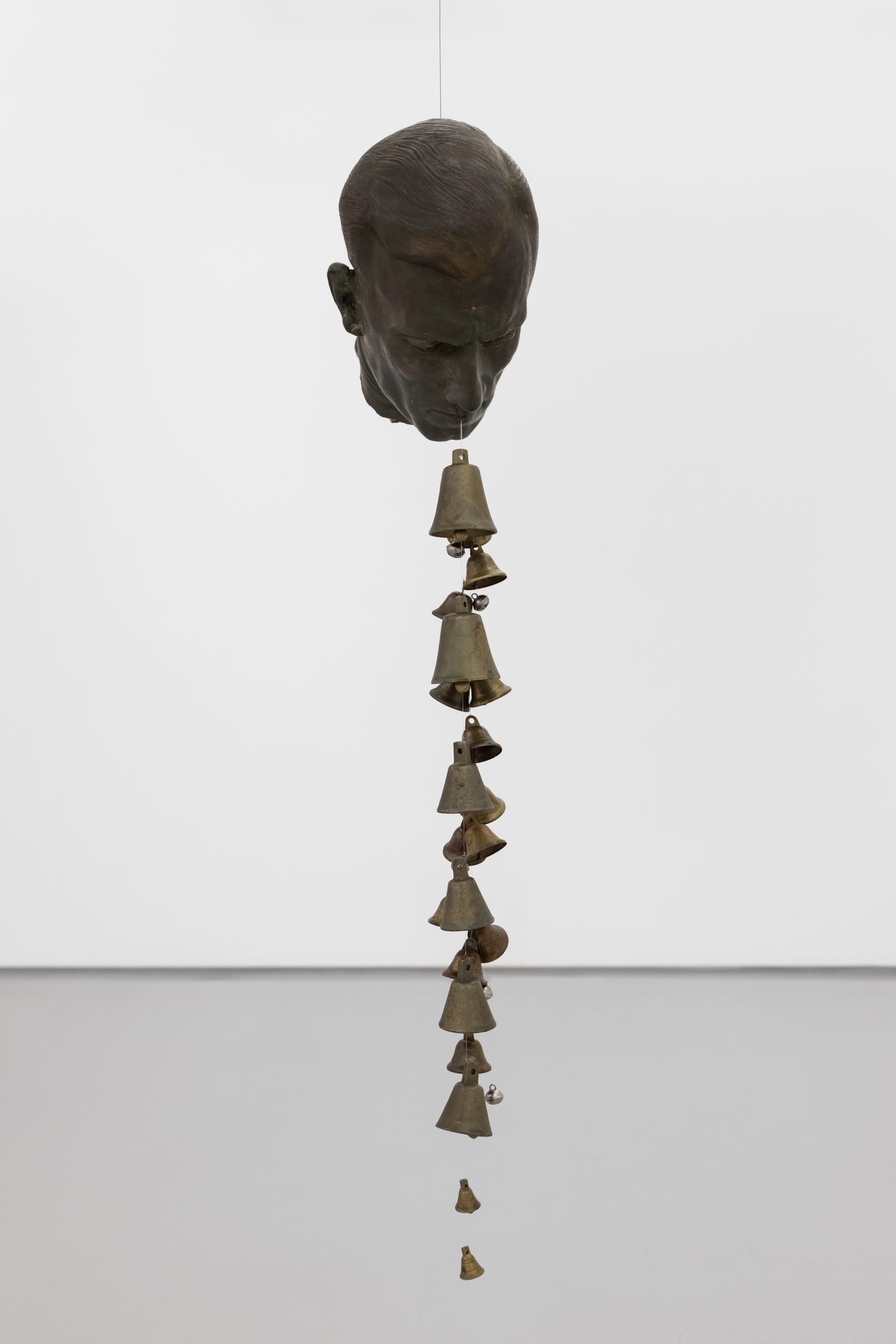 André Romão, Via Lactea, 2026. Sculptural fragment (patinated terracotta, Italy ,1930’s), bells. 93 x 17 x 20 cm
