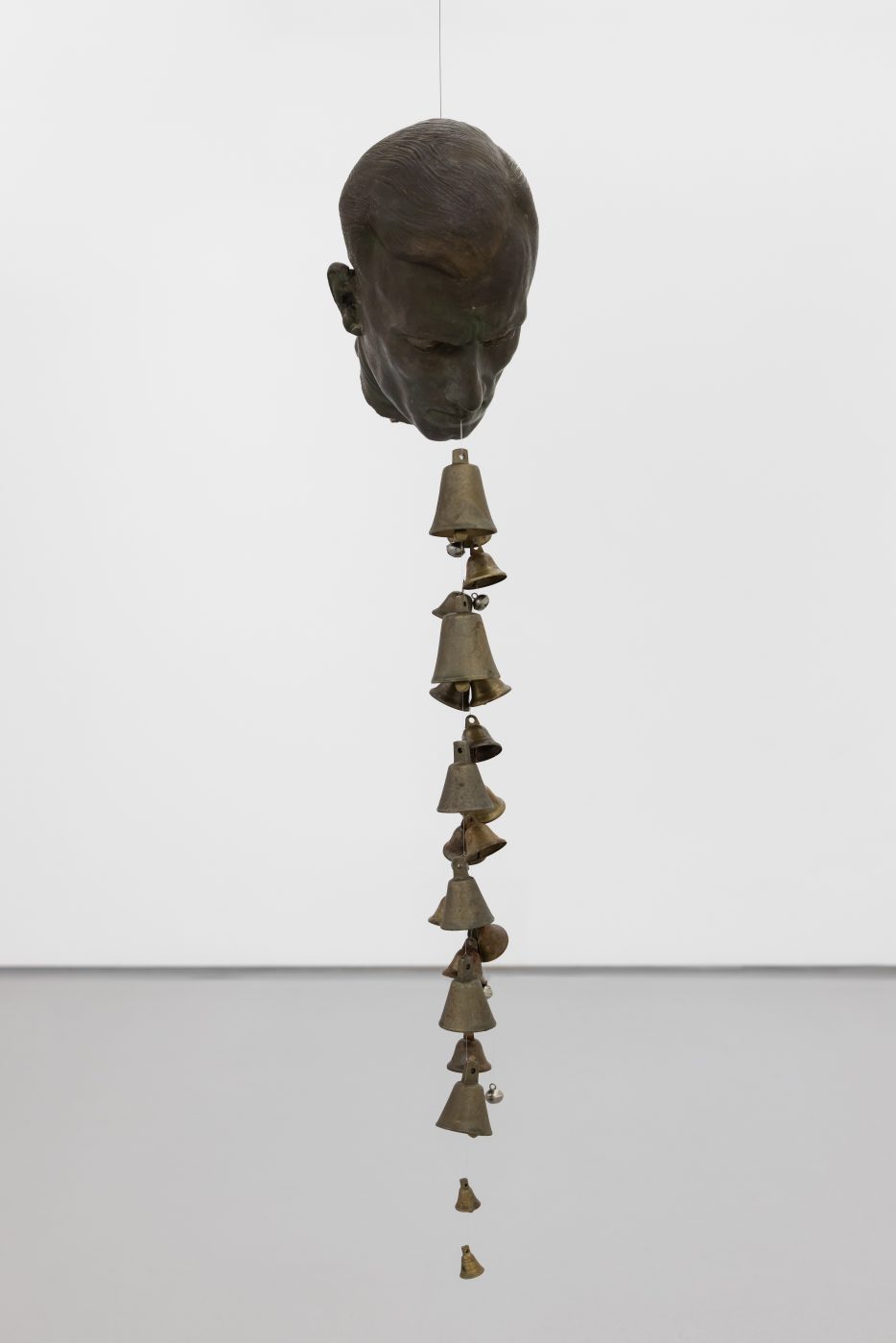 André Romão, Via Lactea, 2026. Sculptural fragment (patinated terracotta, Italy ,1930’s), bells. 93 x 17 x 20 cm
