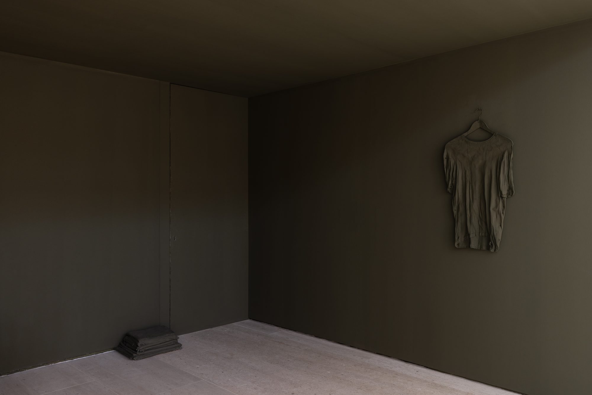 Carlos Bunga, The Place Where We Daily Abandon the World (detail), 2021. Metal bed, mattress, pillow, fabric, lamp, bedside table, wall paint, painted cardboard structure, masking tape, glue paint-soaked t-shirt, hanger. Variable dimensions. Ed. 1
