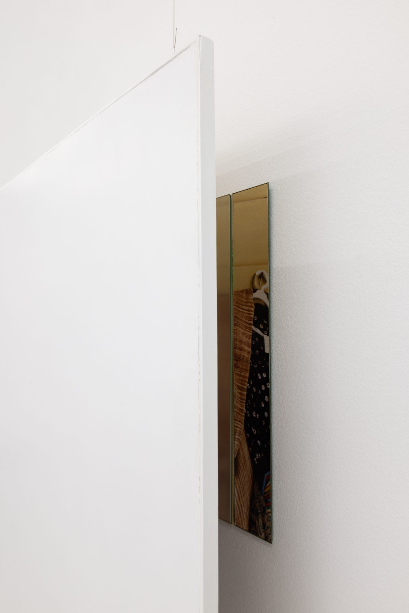 Ana Vieira, Close Up (03), 2004. White panel, photograph, mirrors, and metal cables