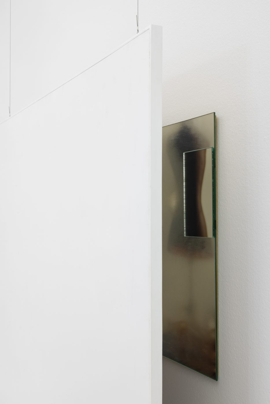 Ana Vieira, Close Up (08), 2004. White panel, photograph, mirrors, and metal cables
